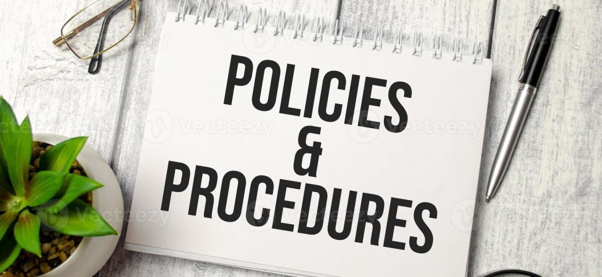 policies-and-procedure-text-on-notepad-with-glasses-pen-and-calculator-photo